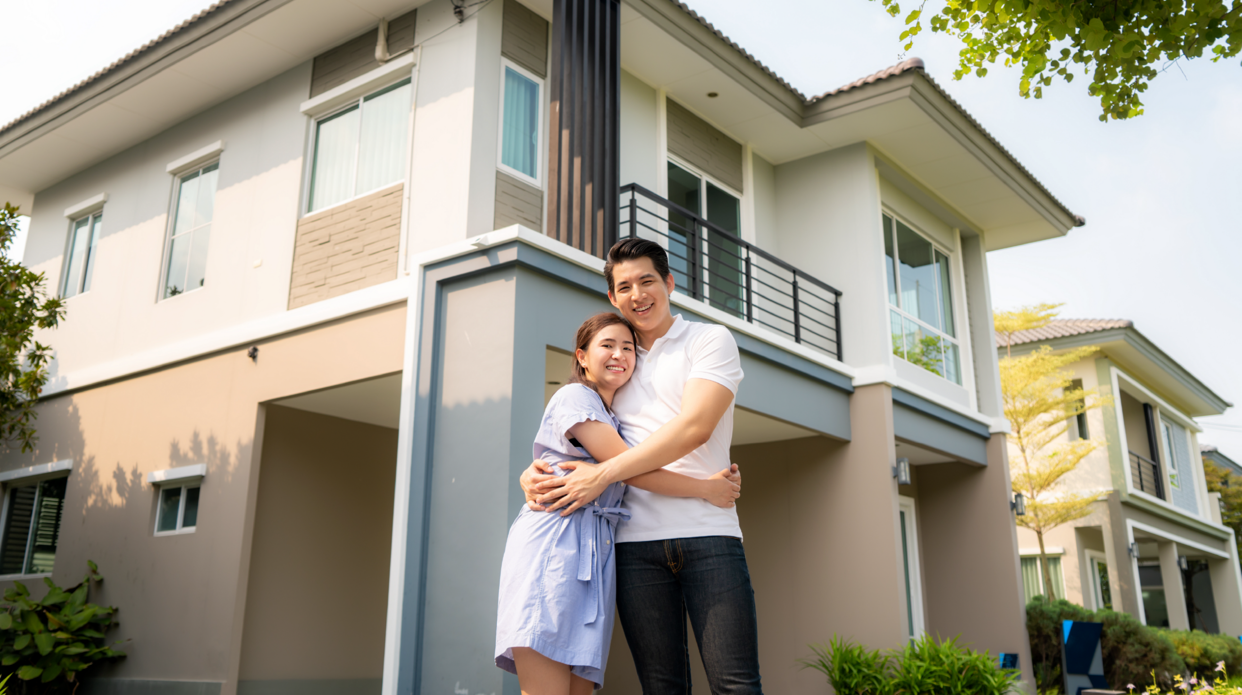 couple in front of new home
